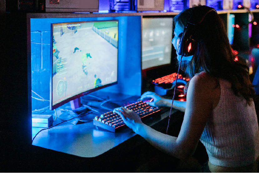 A group of esports players sitting at their computers, surrounded by gaming equipment, compete in a highly intense match.