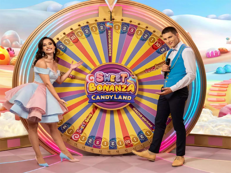 Live game show hosts presenting Sweet Bonanza CandyLand with a colorful spinning wheel in the background.