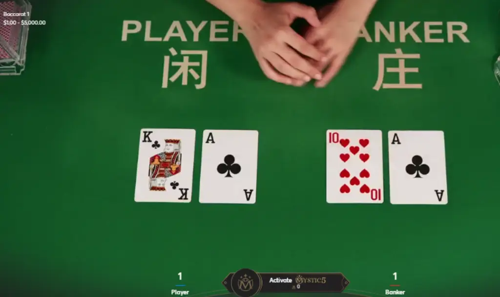 Close-up of a live baccarat game table showing two sets of cards. The player's hand displays a King of Hearts and an Ace of Clubs, while the Banker's hand shows a 10 of Hearts and an Ace of Clubs. Learn Baccarat Tips and Strategies before playing.