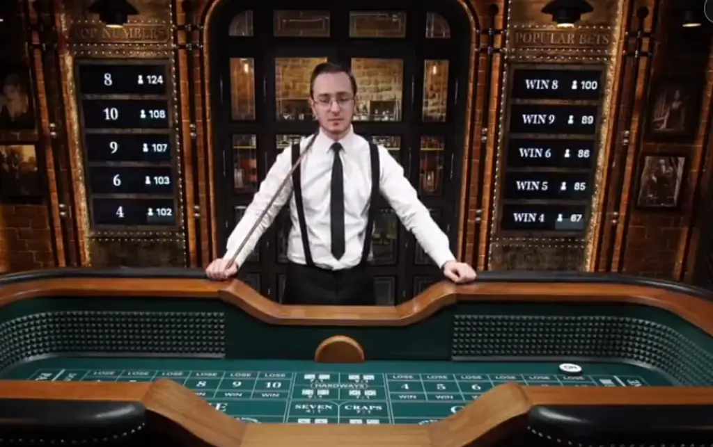 Live Craps is a live table game. A professional live casino dealer standing behind a craps table in an elegant gaming environment, ready to interact with players online